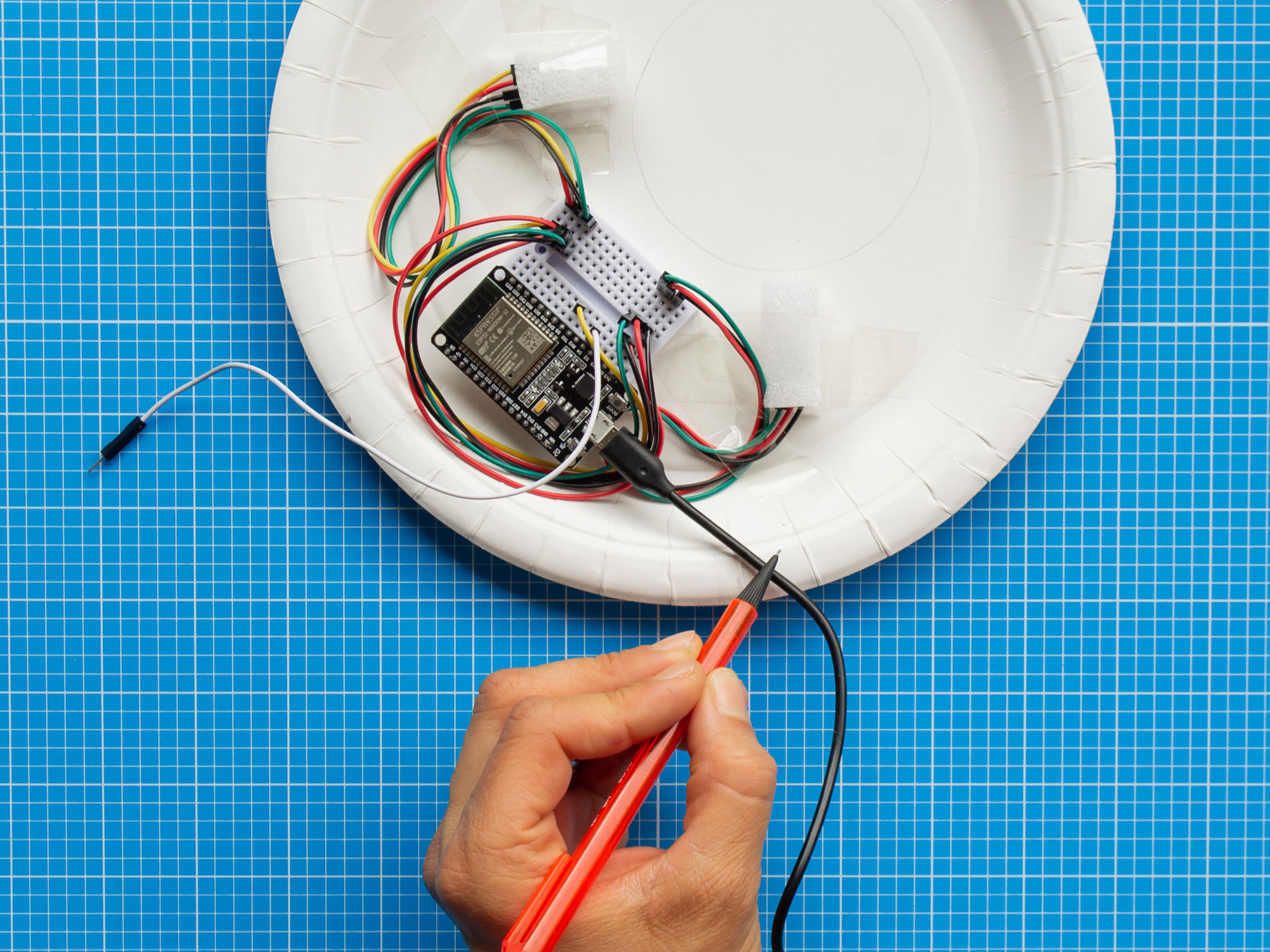 A photograph of a the Light Touch Yo-Yo Machine devices being housed inside paper plates
