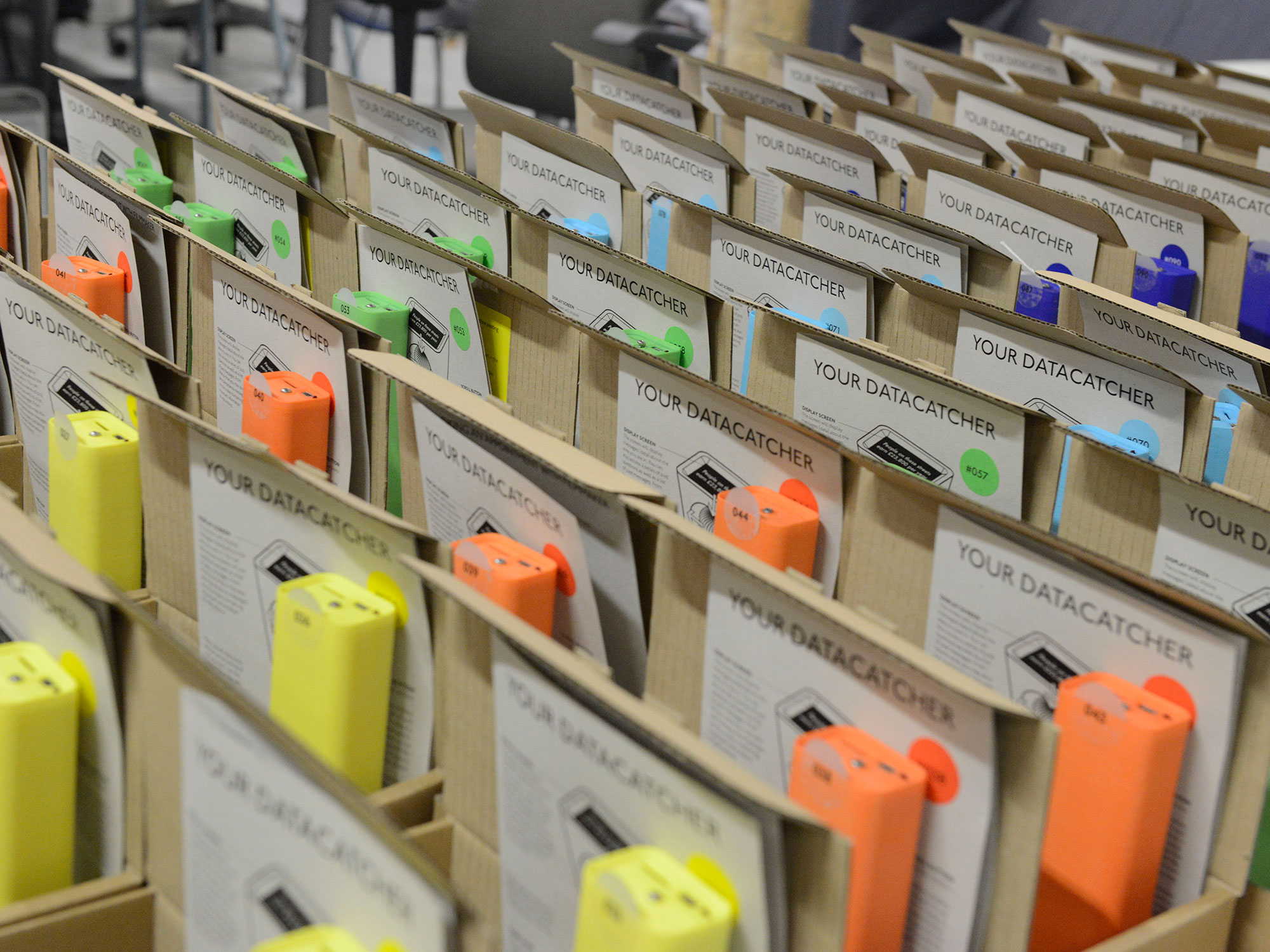A photograph of many Datatcatcher devices packaged inside boxes